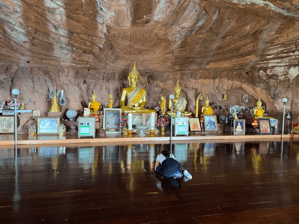 Hidden Thailand: A peaceful Buddhist shrine inside a cave at Wat Phu Tok, Unusual places in Thailand: Golden Buddha statues in a cave temple at Wat Phu Tok, Hidden gems in Thailand: A sacred meditation hall with golden Buddha statues, Best secret spots in Thailand: A tranquil cave temple at Wat Phu Tok, Off-the-beaten-path Thailand: A hidden Buddhist sanctuary built inside a rock cave