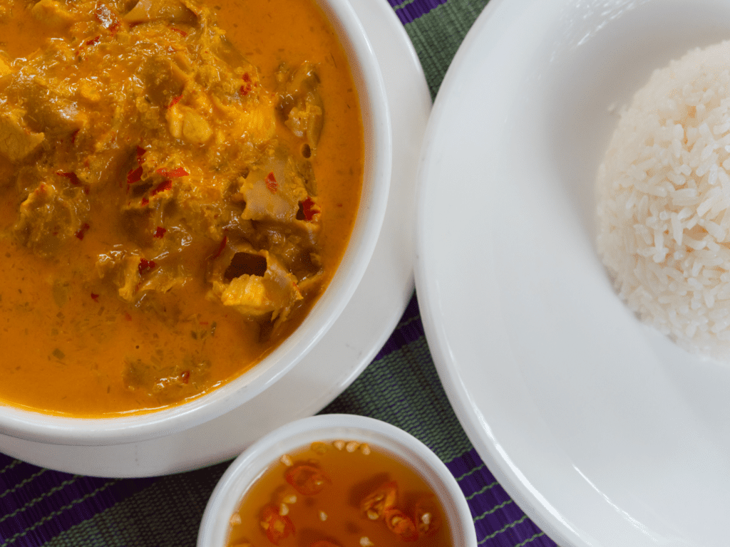 Cambodian red curry with tender meat in a coconut milk-based sauce, served with steamed rice and spicy fish sauce. A popular dish featured in best places to visit in Cambodia for food lovers.