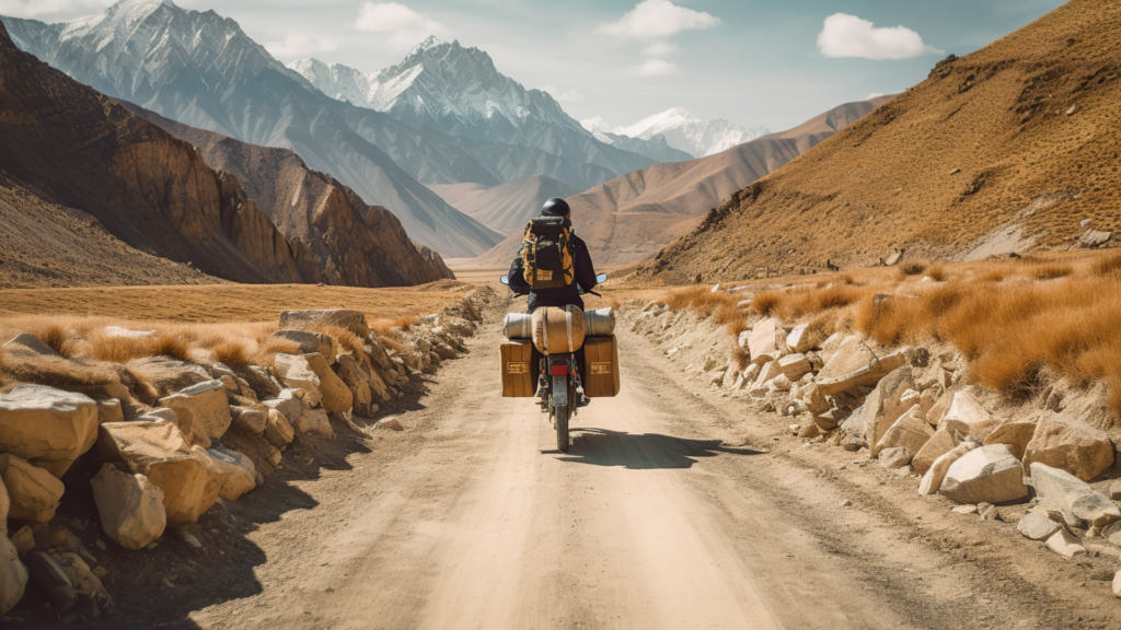 Adventure rider on a fully loaded bicycle traveling a rugged mountain road.