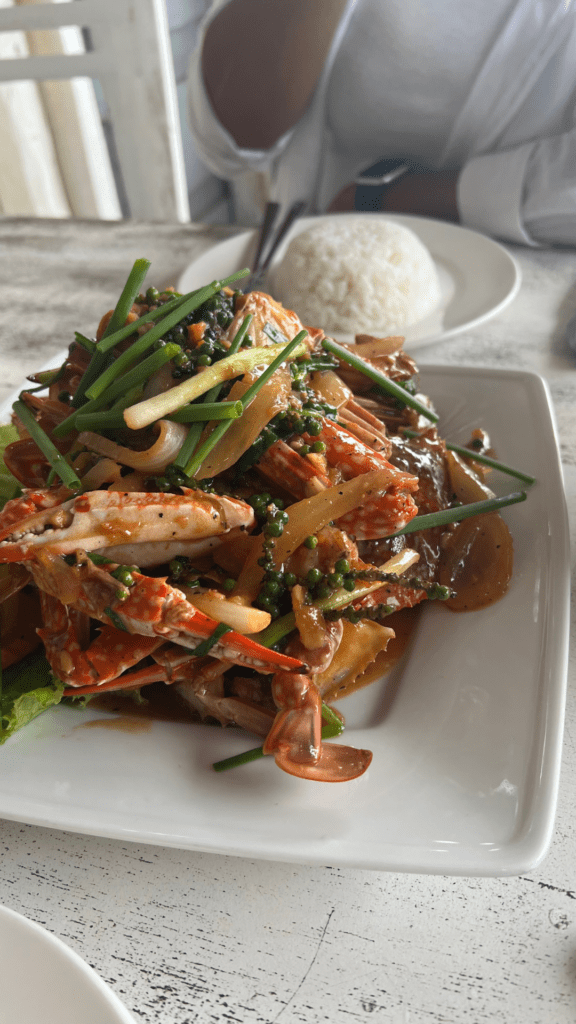 Plate of freshly cooked Kep crab with Kampot green pepper, served with rice at a restaurant in Cambodia.