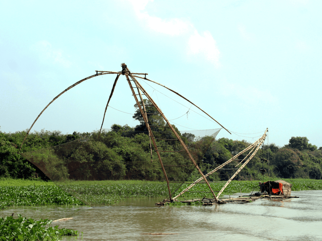 Traditional Cambodian fishing nets on the river in Battambang, showing ancient fishing techniques. A rural experience often featured in Cambodia travel guide recommendations.