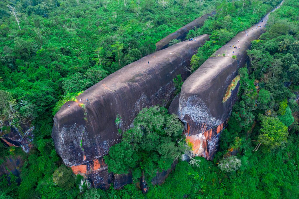 Hidden Thailand: Aerial view of Three Whale Rock, a stunning hidden gem in Thailand, Unusual places in Thailand: Three Whale Rock's massive rock formations in Bueng Kan, Hidden gems in Thailand: Three Whale Rock, an off-the-beaten-path natural wonder, Best secret spots in Thailand: Three Whale Rock surrounded by lush green forest, Off-the-beaten-path Thailand: A breathtaking drone shot of Three Whale Rock's unique formations