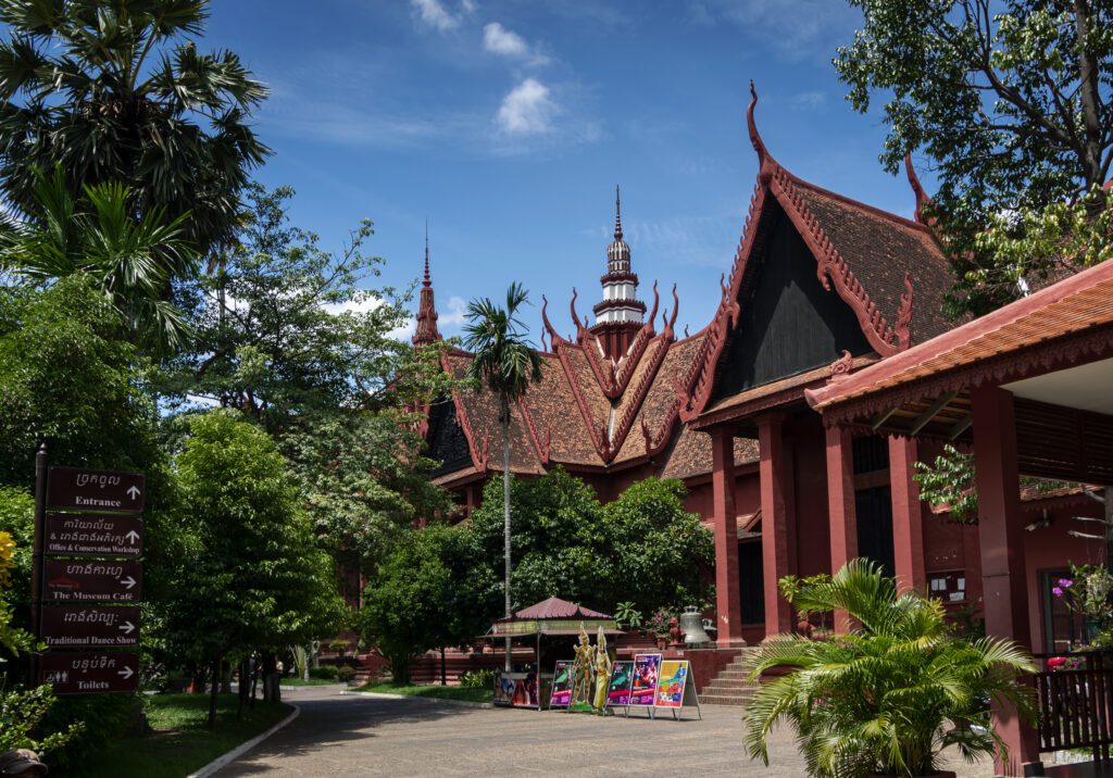 National Museum of Cambodia, Phnom Penh – The exterior of the National Museum of Cambodia, featuring traditional Khmer-style red roofing and lush gardens. A must-see attraction for history and art lovers in Phnom Penh.