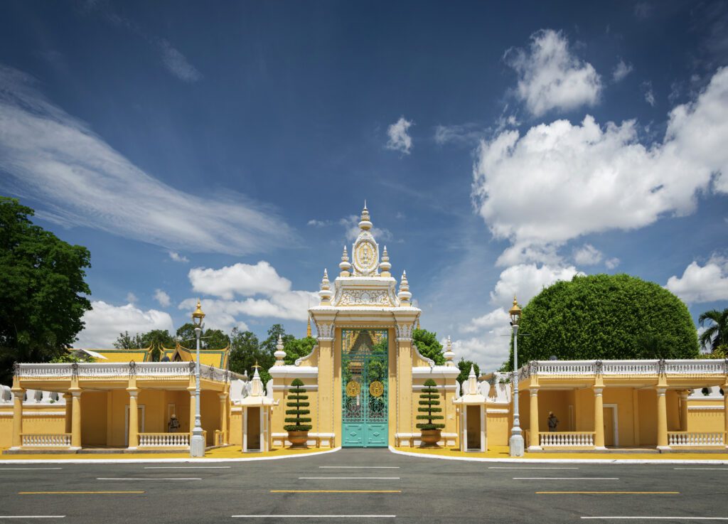 Royal Palace Entrance, Phnom Penh, Cambodia – The stunning entrance gate of the Royal Palace in Phnom Penh, Cambodia, showcasing intricate Khmer architecture under a bright blue sky. One of the top attractions in Cambodia.