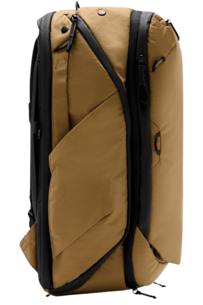 Side view of a coyote-colored travel backpack showcasing its compact and durable design for adventure travel.