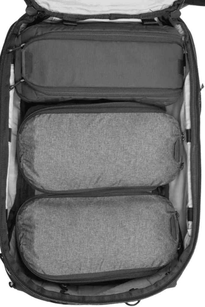 Interior view of a travel backpack packed with travel cubes, showing its efficient organization for minimalist packing.