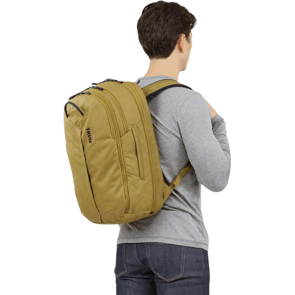 Man Wearing Thule Aion 28L Backpack in Nutria – A male traveler wearing the Thule Aion 28L backpack in Nutria color, showcasing its ergonomic fit and everyday practicality.